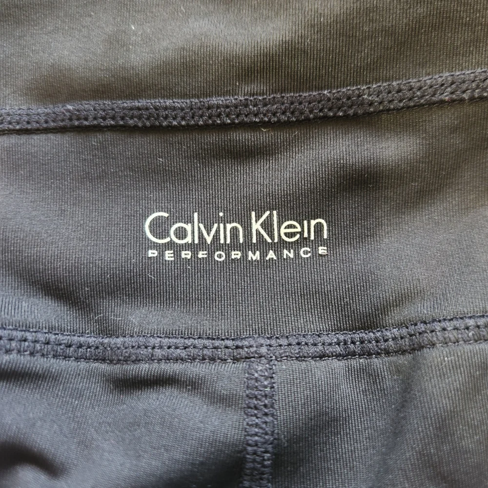 Calvin Klein 20" Cropped Black Leggings with Iridescent "CALVIN" Logo - Picture 2 of 8